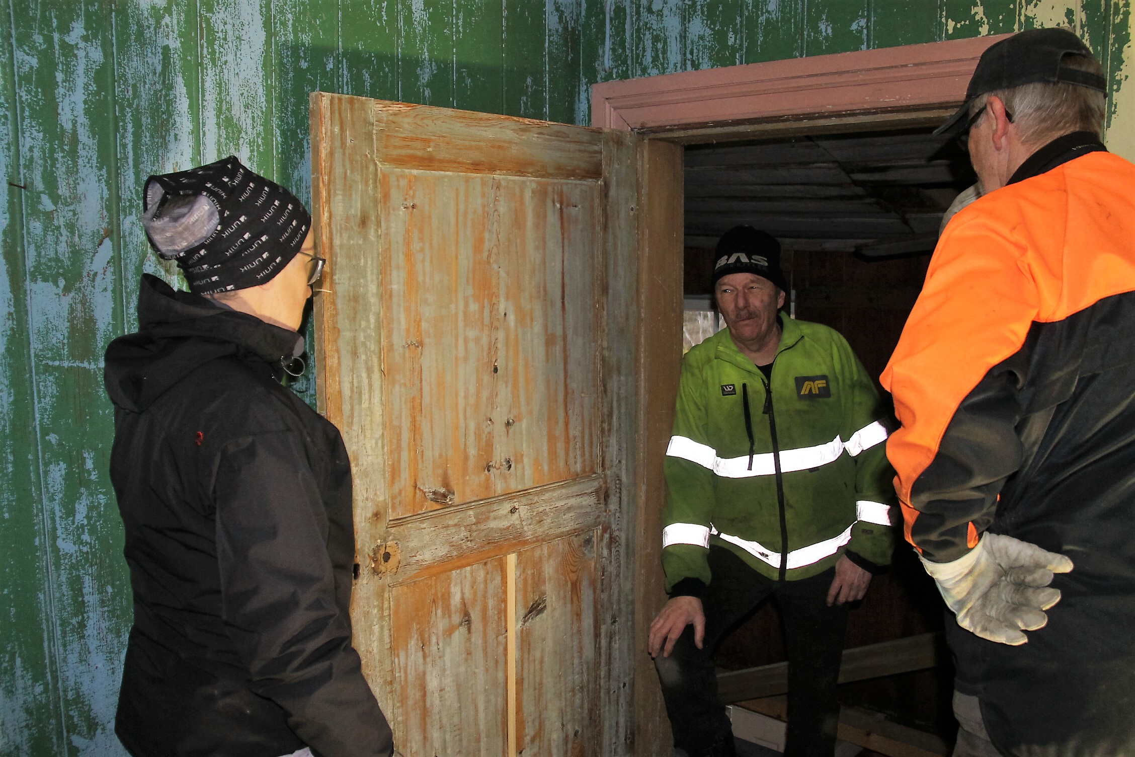 "Dør til historien". En av to dører i bygget fra 1700-tallet er blitt satt i stand av Petter Wistner på en meget profesjonell måte. Ragnhild Nordengen, Jan Berntzen og Ragnar Holte beundrer den nyrestaurerte døra